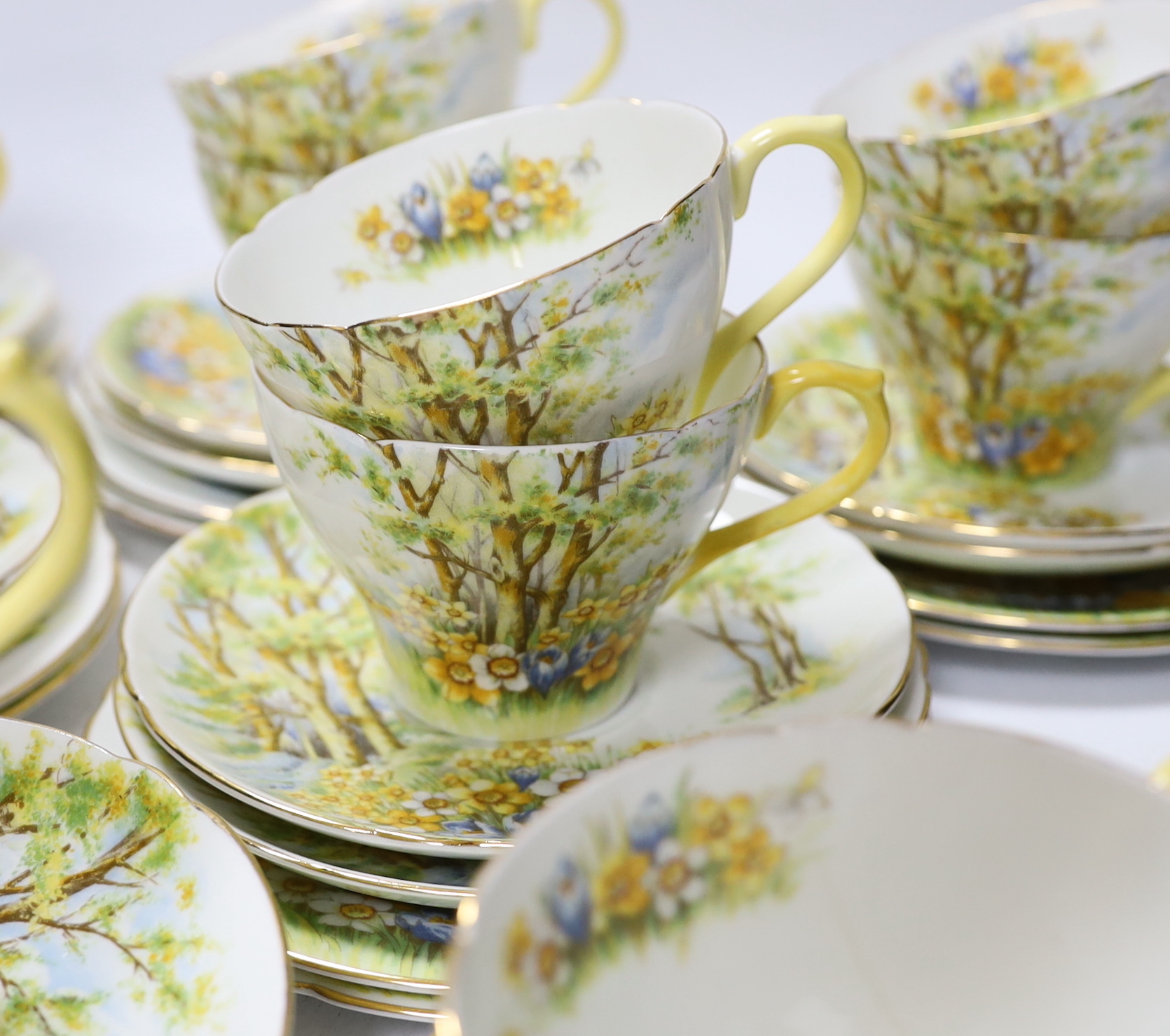 A Shelley ‘Daffodil Time’ pattern tea set with thirteen trios, three sandwich plates, milk jug and bowl, largest 24cm wide